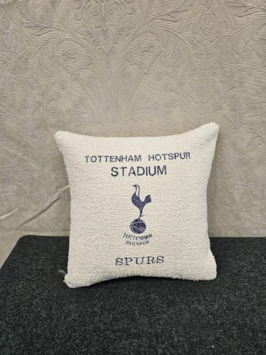 A cushion featuring the Tottenham Hotspur Stadium logo and establishment year, 2019.