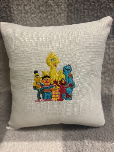 Sesame Street Cartoon cushion featuring Sesame Street characters: Elmo, Cookie Monster, Bert, Ernie, and Big Bird.
