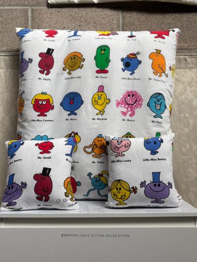 Four cushions featuring various colourful characters from the "Mr. Men" series.
