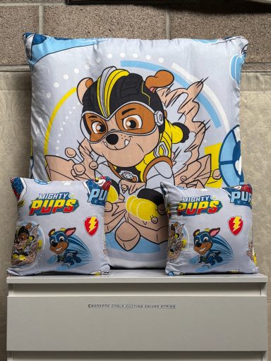 Four cushions featuring a cartoon character with a blue, yellow, and grey design.