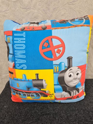 Colourful cushion featuring Thomas the Tank Engine with vibrant block designs.