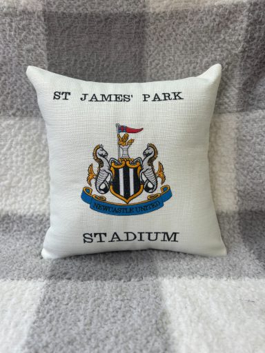 Cushion featuring the St James' Park Stadium logo and text.