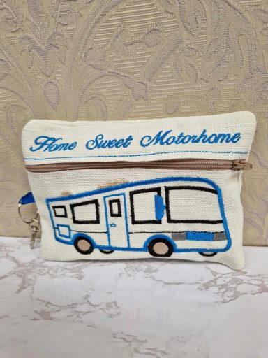 A cream pouch with a blue illustration of a motorhome and the text "Home Sweet Motorhome".
