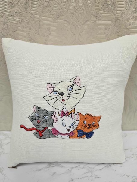 Four cartoon cats in various colours, featuring playful expressions and bright collars.