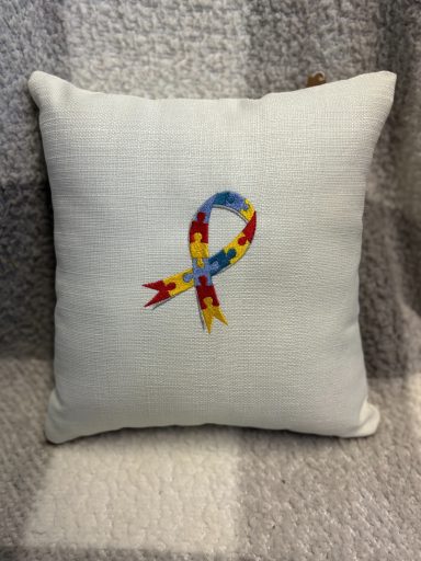Decorative cushion featuring a colourful awareness ribbon design.
