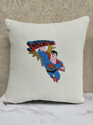 Superman flying with the word "Super" above him, printed on a cream cushion.
