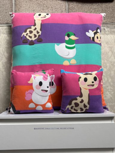 Colourful cushions featuring cartoon animals on striped backgrounds.