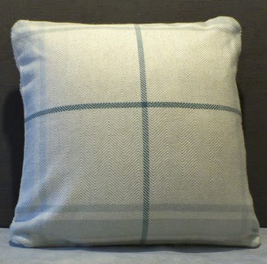 Square cushion with a light grey base and blue grid pattern.