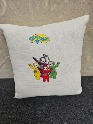 Square cushion featuring Teletubbies characters with the logo in yellow at the top.