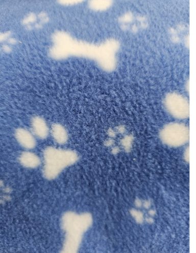 Blue fleece fabric with white paw prints and bone patterns.