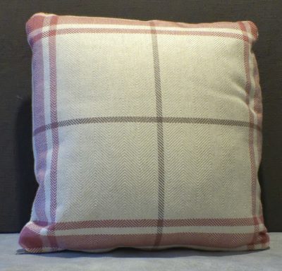 Square cushion with a beige background and pink checkered pattern.