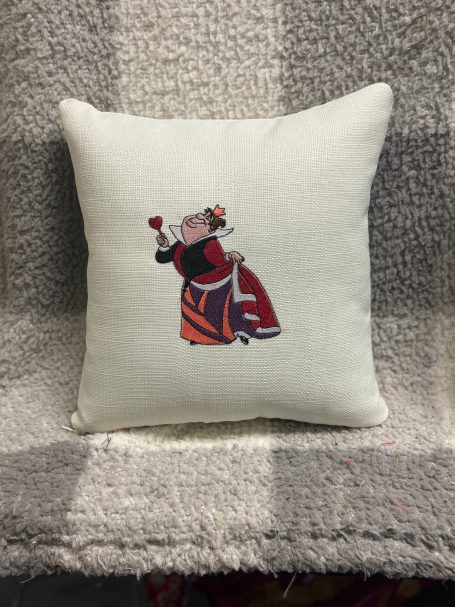 Decorative cushion featuring a woman in traditional dress holding a rose.