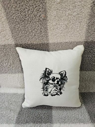 Cushion with a black and white illustration of a dog on a textured fabric background.