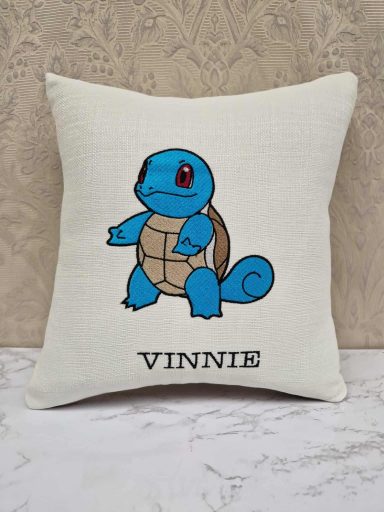 A textured cushion featuring a blue Squirtle cartoon and the name "VINNIE".